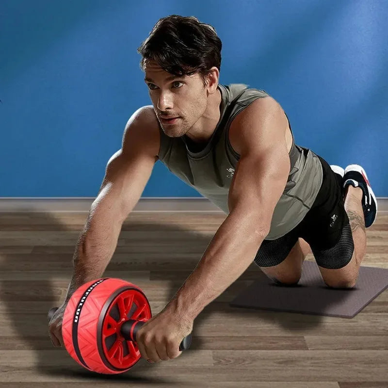 Man using a red and black dual-wheel ab roller on a yoga mat for core strength training.